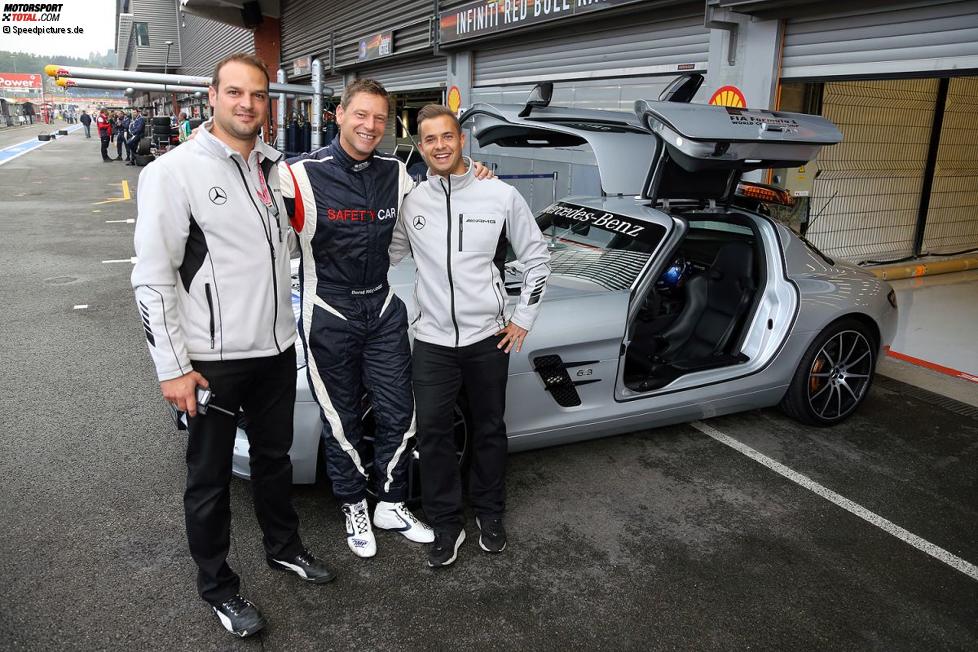 Bernd Mayländer und die zwei zuständigen AMG-Mechaniker vor dem Safety-Car, einem Mercedes-Benz SLS AMG