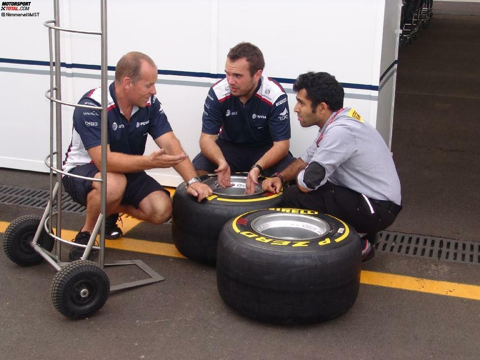 Williams-Mechaniker beraten sich mit einem Pirelli-Ingenieur über die richtige Handhabung der Reifen.