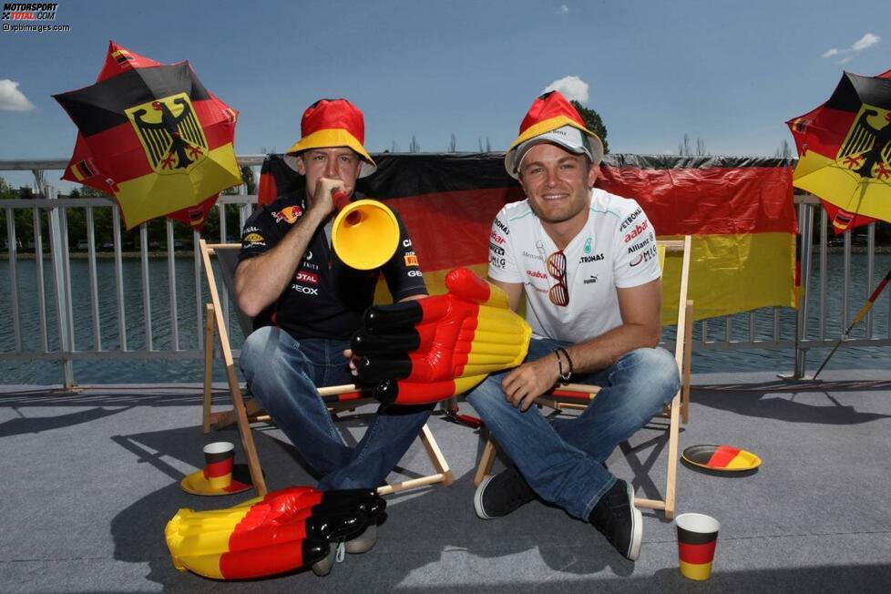 Sebastian Vettel und Nico Rosberg sind bekennende Fußballfans, aber die Europameisterschaft ist längst vorüber. Diesmal stimmten sie sich in Schwarz-Rot-Gold auf ihren Heim-Grand-Prix ein, den beide noch nie gewonnen haben.