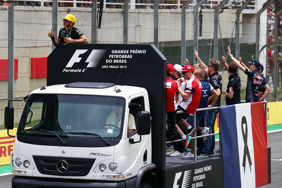 Der darf sogar bei der Fahrerparade mit auf den Truck, ist inzwischen bester Kumpel von Daniel Ricciardo & Co. Einige Fans stört aber etwas ganz anderes: Während die Formel 1 mit Tricolore und Black Ribbon den Terroropfern von Paris gedenkt, lässt sich Weltmeister Hamilton feiern, als wäre nichts gewesen. Das kommt nicht bei allen gut an.