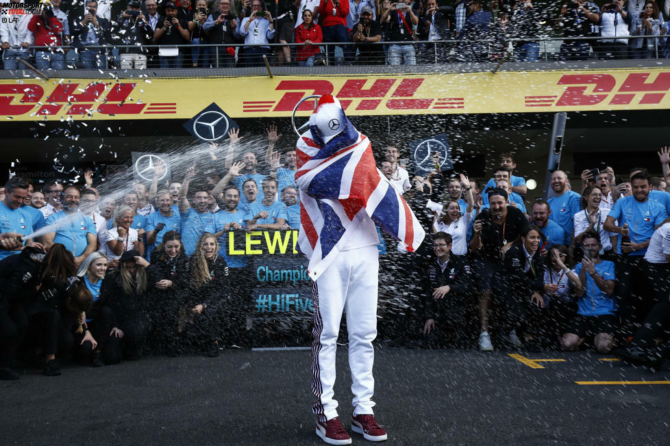 Plötzlich spritzt Champagner und das Team stürzt sich auf Hamilton ...