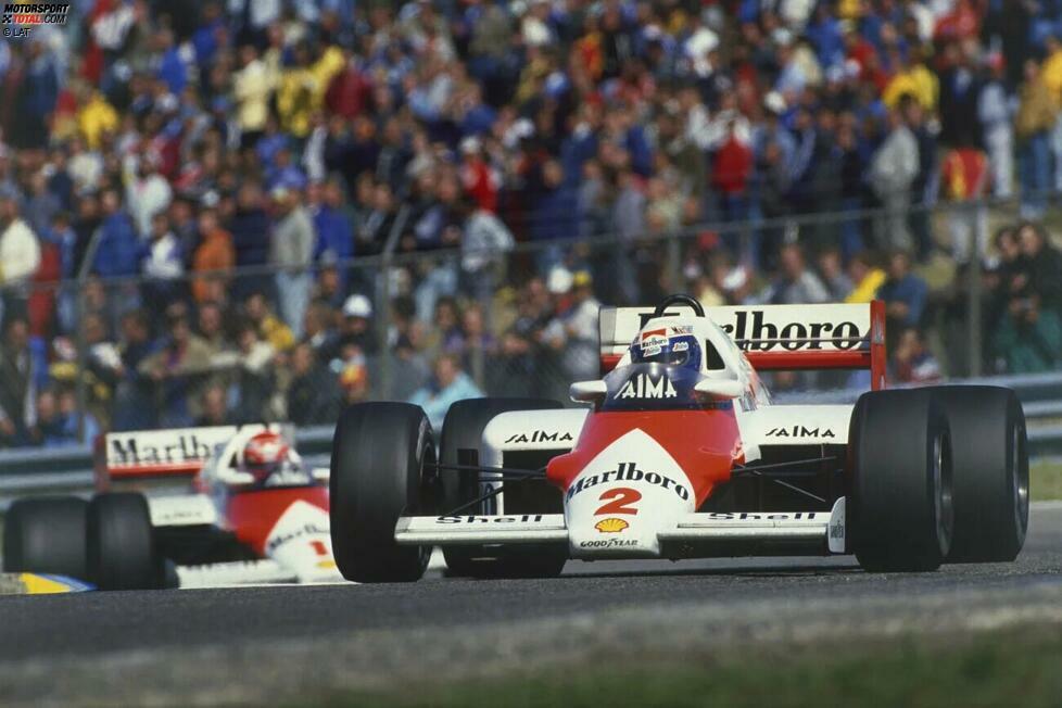 Alain Prost: Nach Brabhams Triumph 1960 dauert es 26 Jahre(!), bevor überhaupt wieder ein Fahrer erfolgreich seinen Titel erfolgreich kann. 1985 und 1986 gewinnt der Franzose für McLaren seine ersten beiden Weltmeisterschaften. Und auch 1987 startet er zunächst wieder mit zwei Siegen in den ersten drei Rennen ...