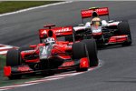 Lewis Hamilton (McLaren) Timo Glock (Virgin) 