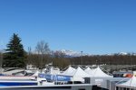 Blick vom Fahrerlager auf die schneebedeckten Alpen