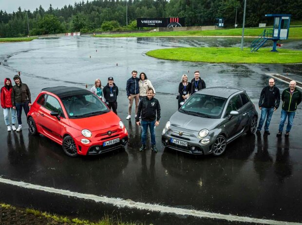 Abarth-Aktion: Gruppenfoto von oben mit allen Teilnehmern zwischen zwei Autos Abarth-Aktion: Gruppenfoto von oben mit allen Teilnehmern zwischen zwei Autos