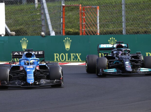 Titel-Bild zur News: Heißes Duell: Fernando Alonso (Alpine) verteidigt sich beim Grand Prix von Ungarn 2021 auf dem Hungaroring bei Budapest gegen Lewis Hamilton (Mercedes)