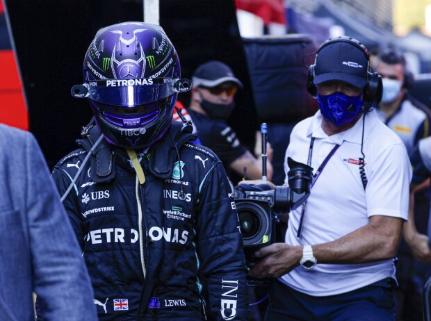 Titel-Bild zur News: Lewis Hamilton (Mercedes) geht nach dem Crash mit Max Verstappen (Red Bull) beim Grand Prix von Italien in Monza 2021 enttäuscht zurück an die Box und wird dabei von einem Kameramann verfolgt