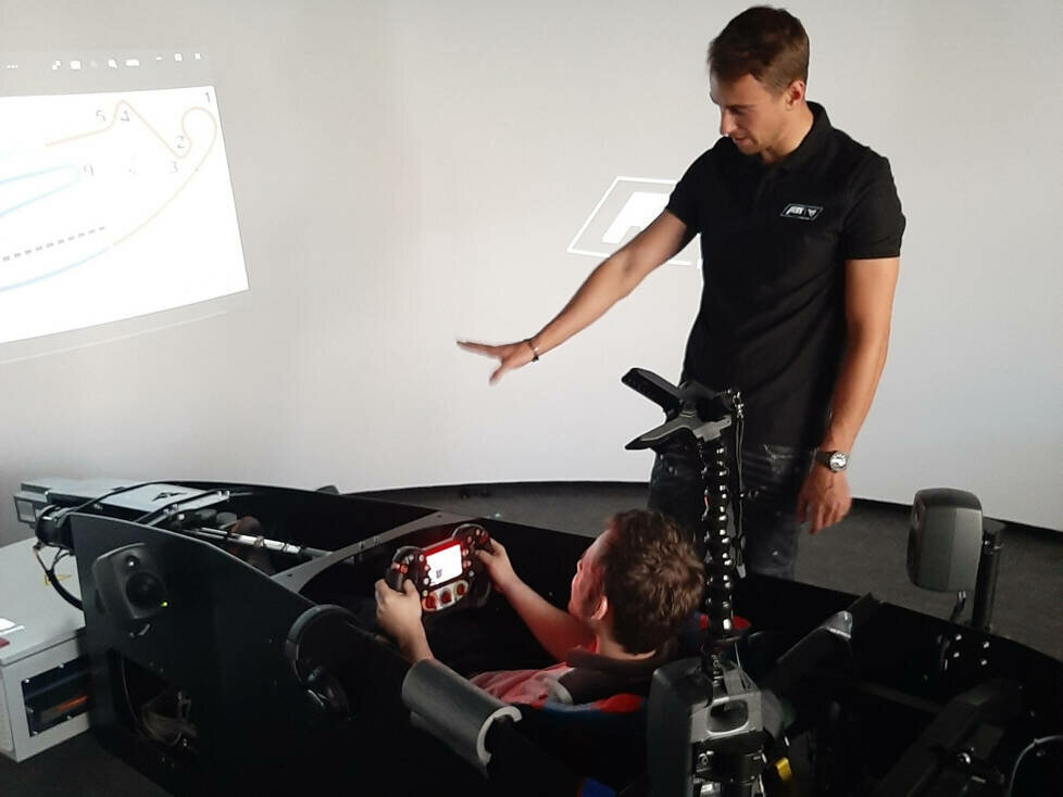 Nico Müller erklärt Norman Fischer den Formel-E-Simulator von Abt