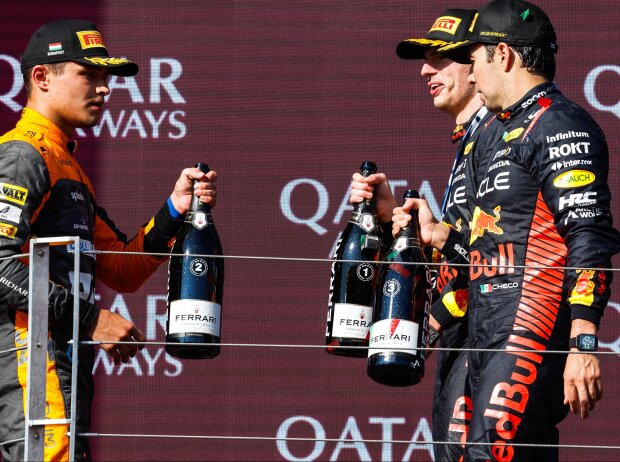 Titel-Bild zur News: Lando Norris, Max Verstappen und Sergio Perez auf dem Formel-1-Podium in Ungarn
