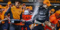 Lando Norris besprüht seinen McLaren-Teamkollegen Oscar Piastri mit Schaumwein